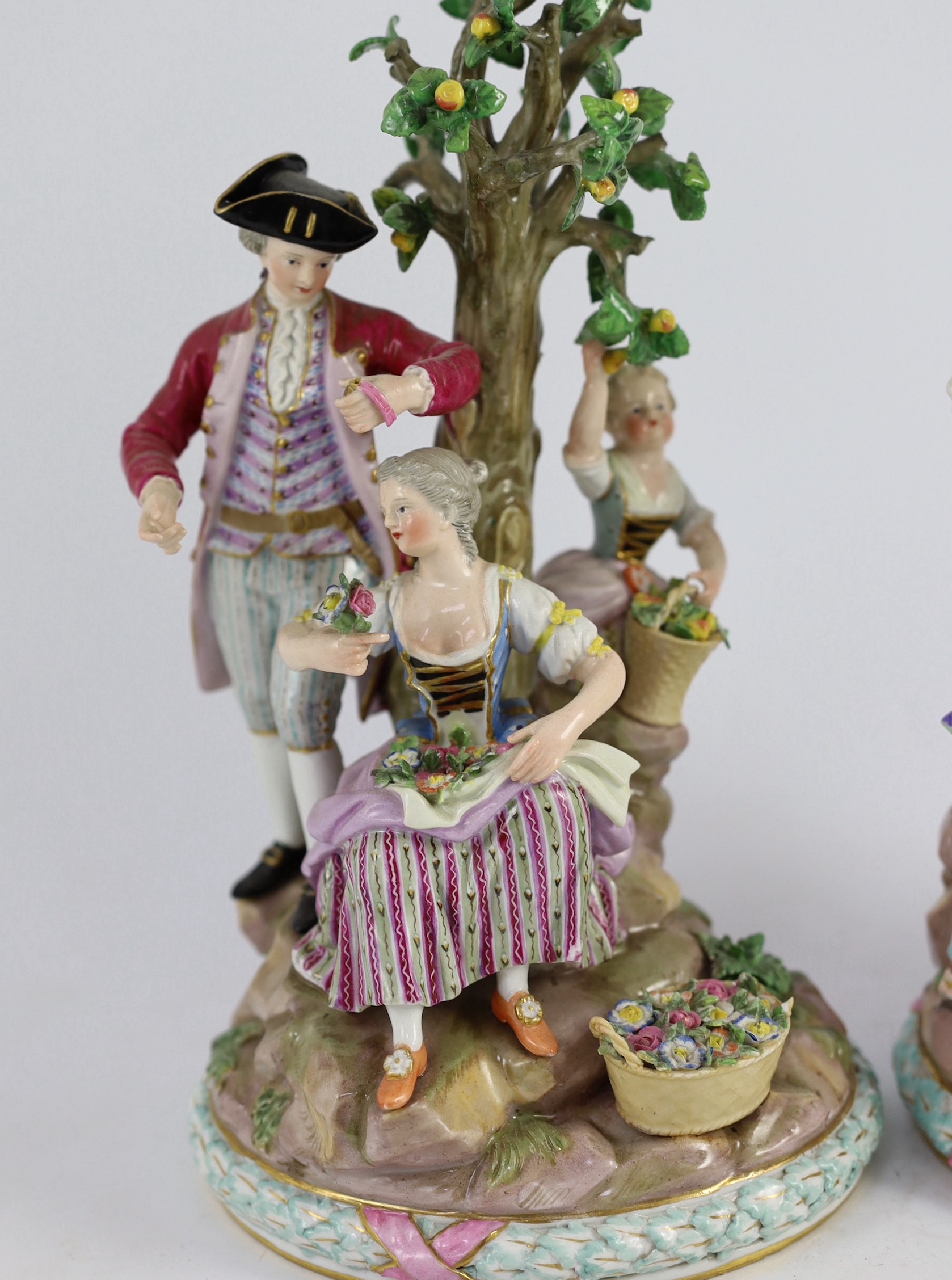 A pair of Meissen groups of apple pickers and flower gatherers, 19th century, 26cm and 27.5cm high